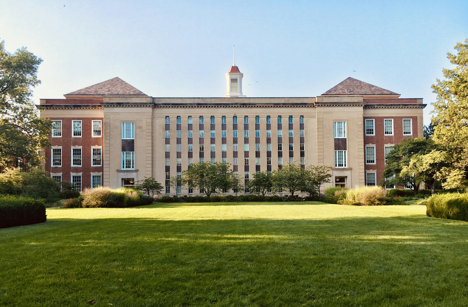 University campus buildings overlooking a green lawn
